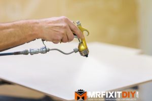hand sprays urethane finish on wood - an idiot's guide to woodworking