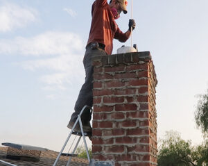 How To Clean Chimney - Ram the cleaning brush up and down several times in a small section of the flue to remove chimney soot.